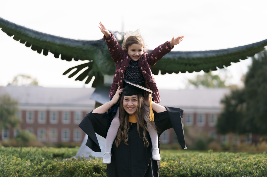 uncw graduate holding daughter UNCW graduate